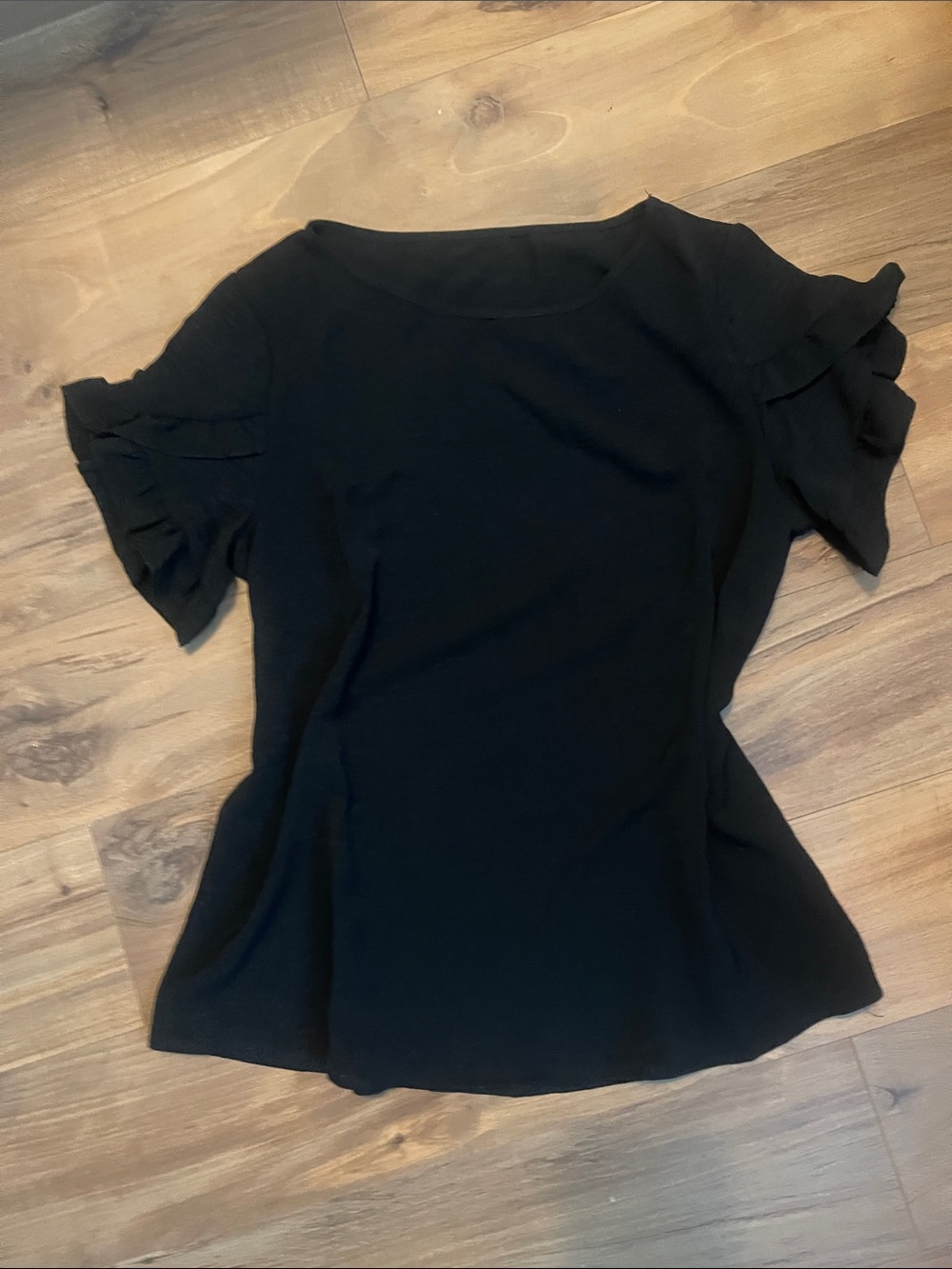Woman’s black ruffle sleeve blouse